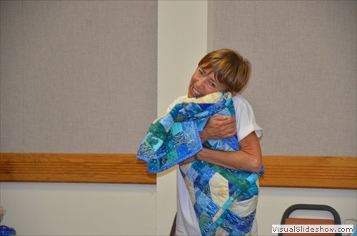 Mary Bowman, loving the quilt made by Margie Mitchell